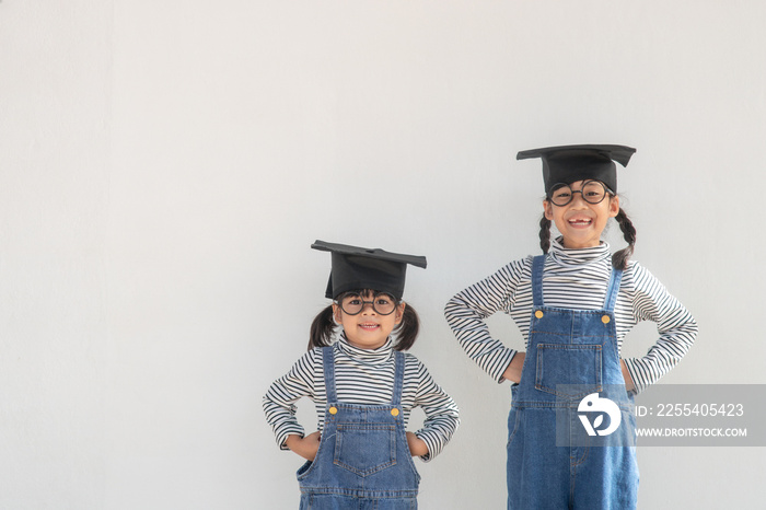 Siblings children girl graduation with cap