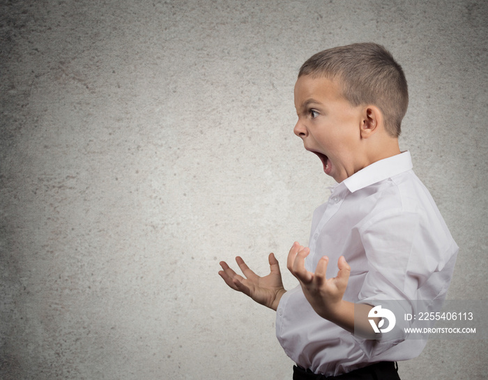 Angry Boy Screaming, side view profile, grey wall background