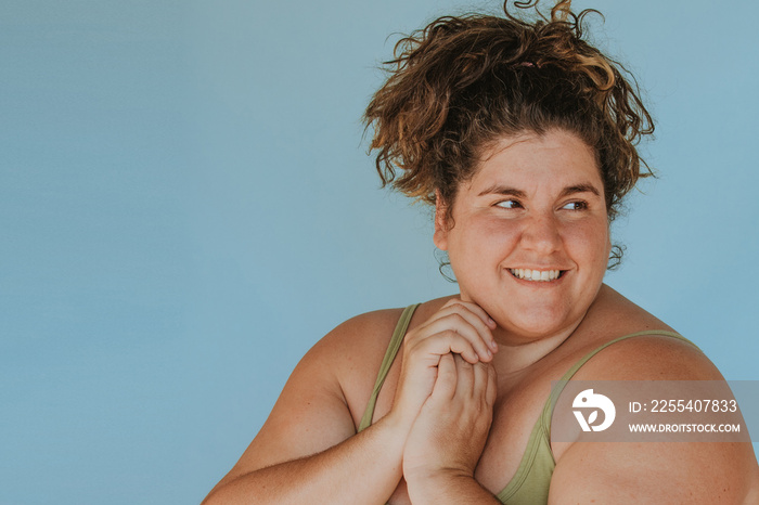 closeup portrait of a plus size woman with curly hair hands clasped