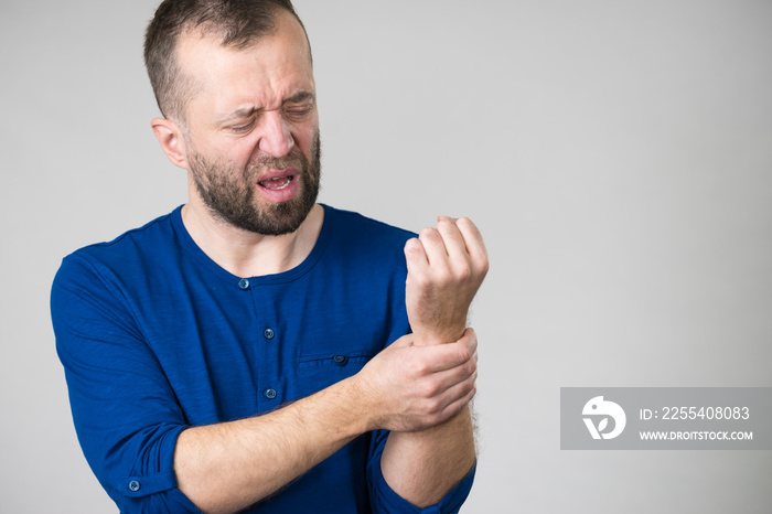 Man feeling pain in wrist