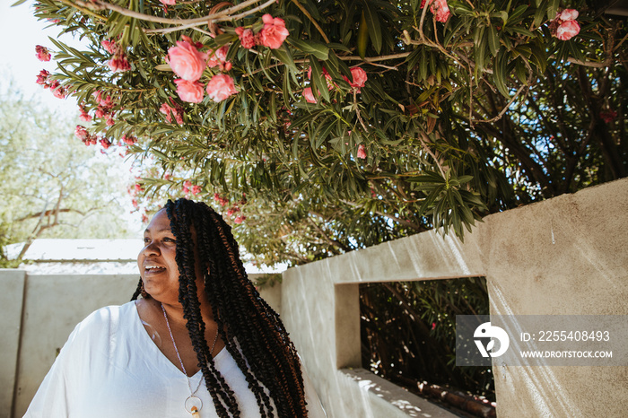 portrait of a plus size afro latinx haitian american woman smiling looking away