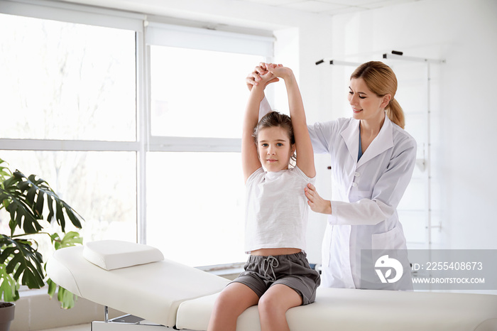 Physiotherapist working with little girl in rehabilitation center