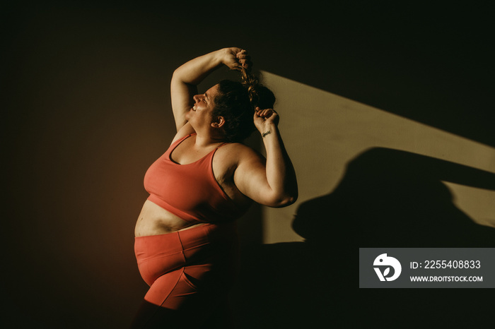 plus size woman wearing athletic gear faces the sun