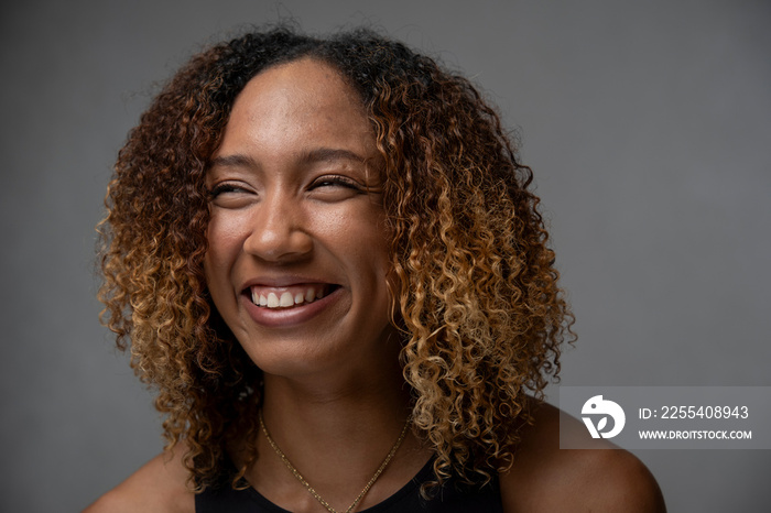 Portrait of smiling woman with curly hair