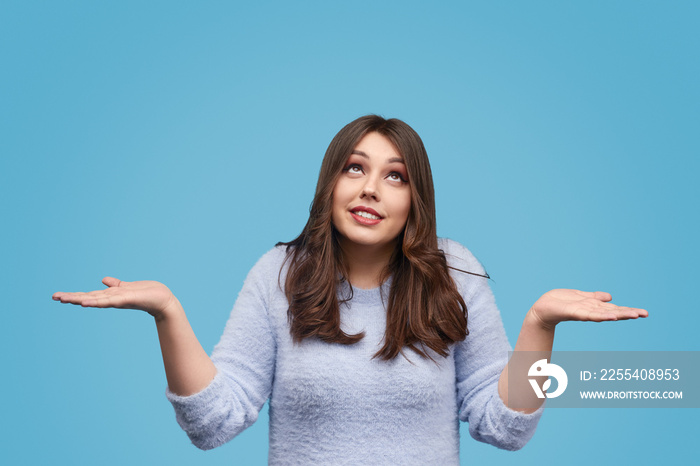 Overweight woman shrugging shoulders