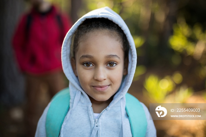 Close-up of cute girl standing with school bag