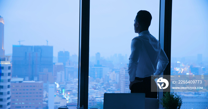 Businessman look through window