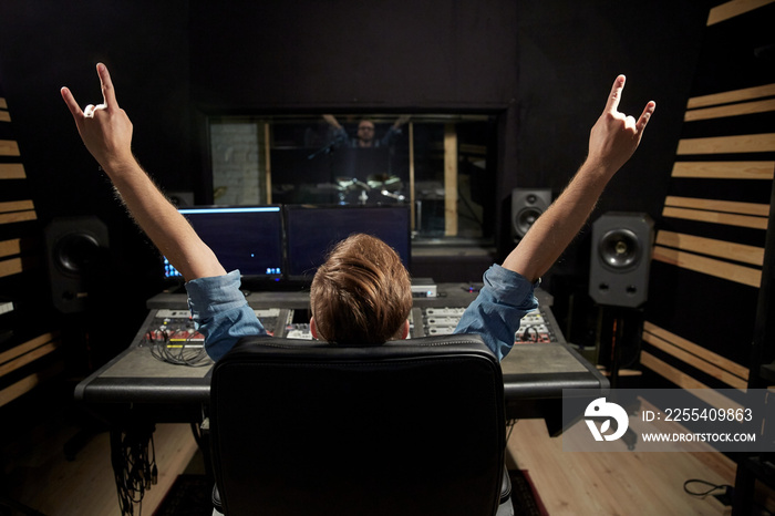 man at mixing console in music recording studio