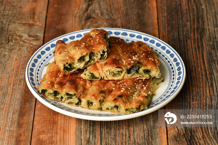 Traditional Turkish pastry with spinach. (Turkish Name: Ispanakli Kol Boregi). Handmade pastry with spinach filling.