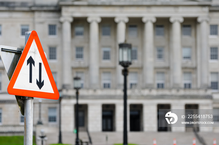 Two way traffic road sign outside Parliament Buildings, Stormont Estate symbolising negotiation and compromise between political parties.