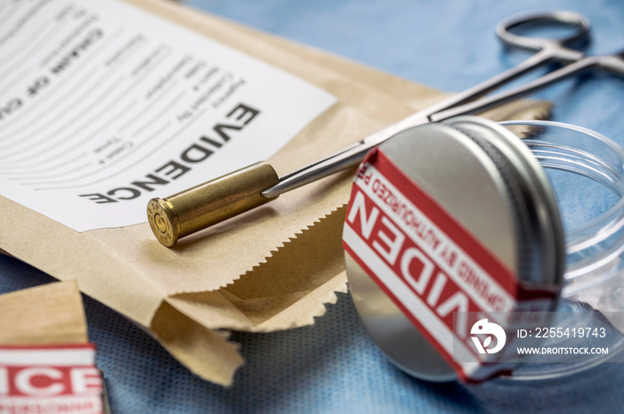 Bullet cap next to a test bag in  ballistic Laboratory, conceptual image