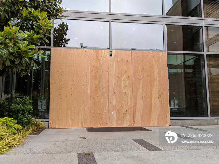 boarded up windows and doors in a downtown building during protests and riots