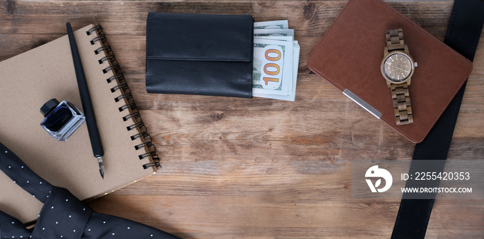 empty blank for text, black tie, money American dollars in a purse, wrist watch, e-book in a leather case, top view on items, men’s style concept, father’s day gift