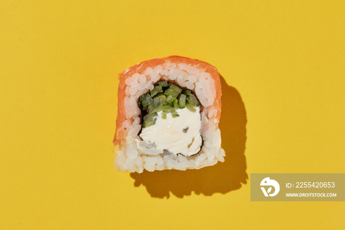 Fresh sushi roll philadelphia on yellow background.