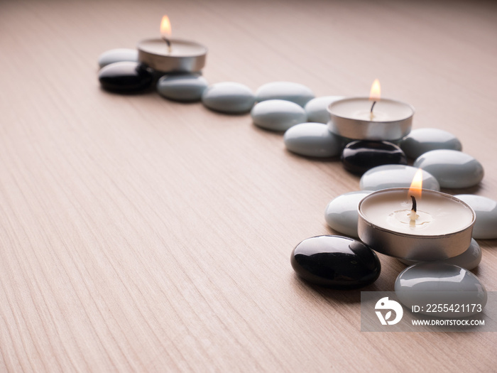 Spa still life concept,Close up of spa theme on wood background with burning candle and bamboo leaf and flower