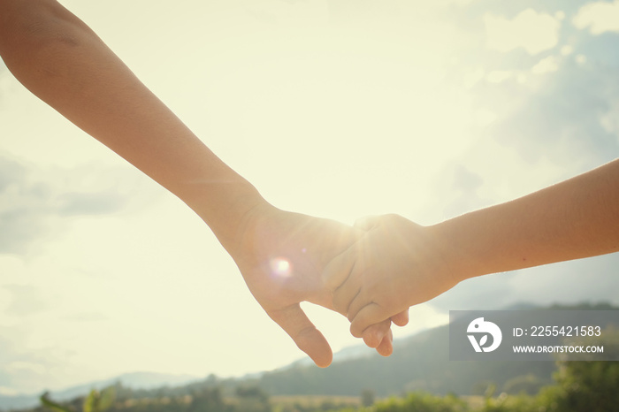 Brother and sister hold hands.Happy in making merit. Mother’s love in the hand, on the palm