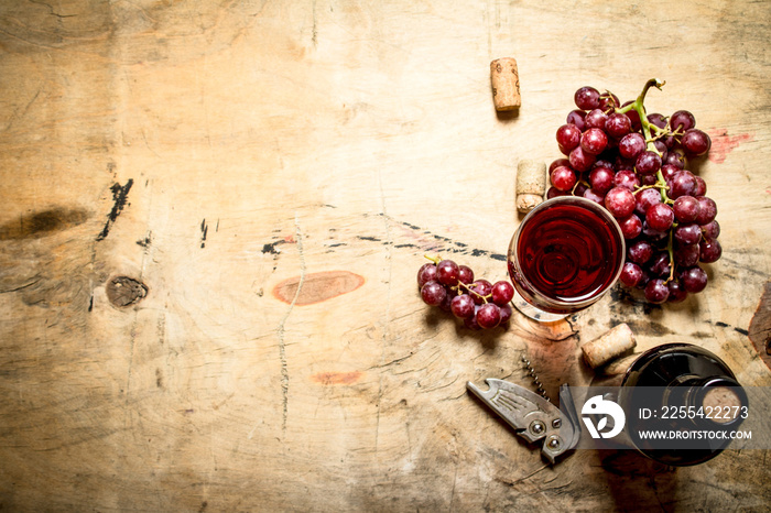 Red wine with grapes and corks.