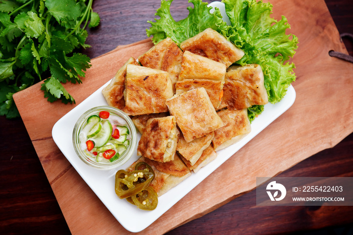 Mutabbaq Roti, Pancakes Stuffed with Beef or fried bread, cut into pieces