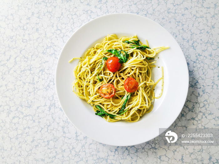 Pasta with pesto sauce and nuts on a the table