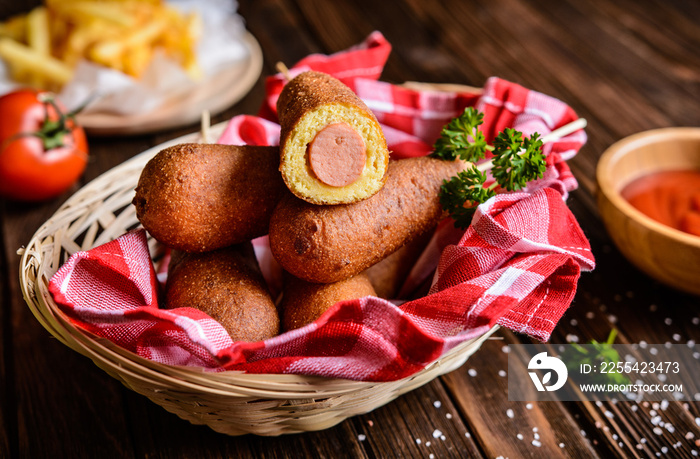 Homemade corn dogs with fries, ketchup and mustard