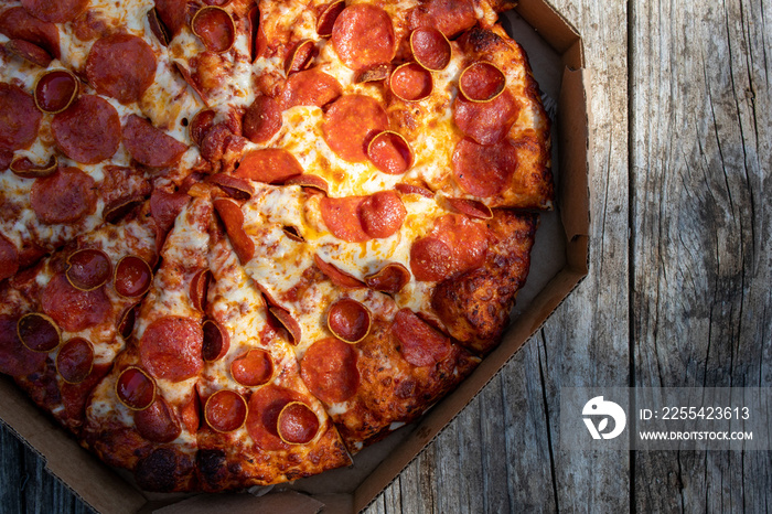 Pepperoni Pizza on a wood table at an outdoor picnic