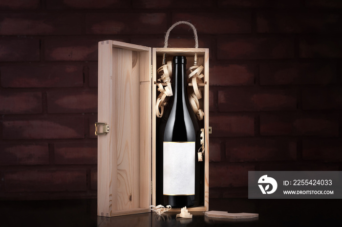 Bottle of wine in a wooden case against a brick wall background. Presentation of wine in the warehouse.