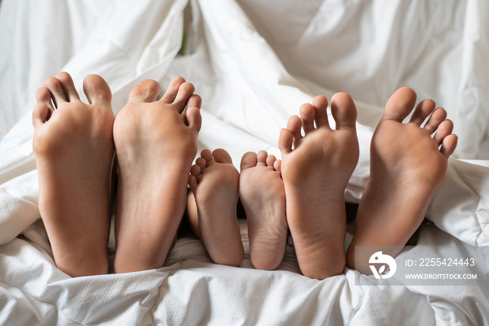 three siblings showing their bare foot. Concept of hygiene, togetherness and friendship