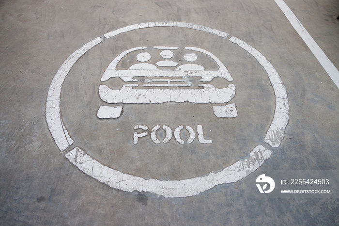 carpool sign on concrete floor at parking lot.