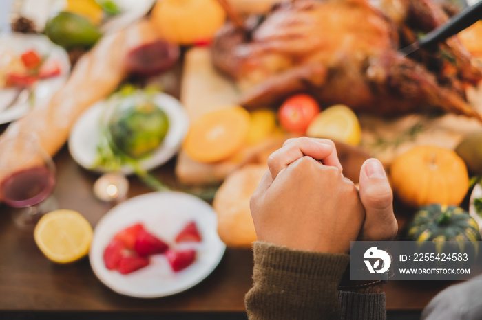 Happy Thanksgiving dinner at home, praying and blessing before having dinner