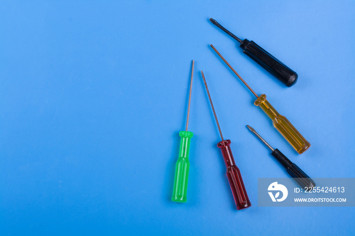 small screwdriver tools on wooden background