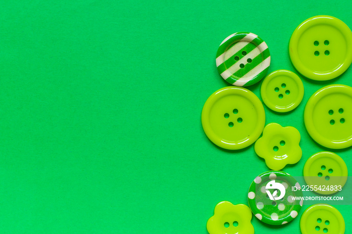 Various green sewing buttons  on green background