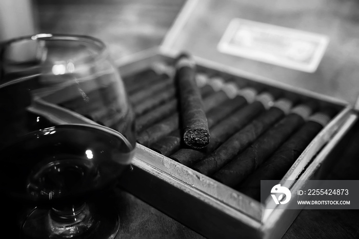 Retro styled photo of large box of Cuban cigars on a wooden tabl