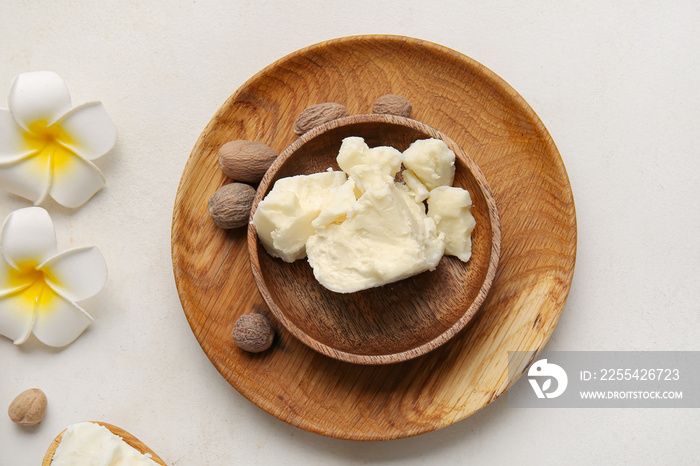 Plate with shea butter on light background