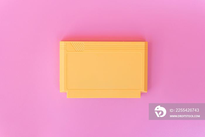 8 bit game cartridge  for retro game console on pink background. Minimal concept.