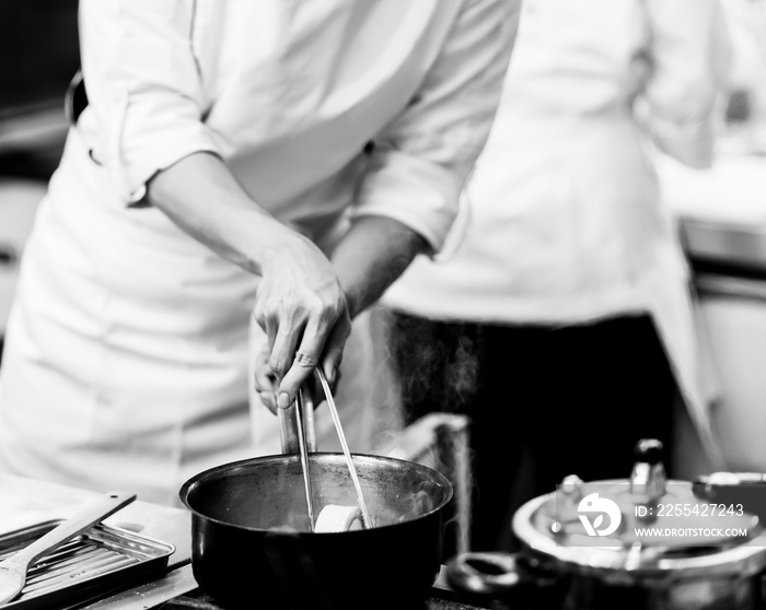 chef preparing food, chef cooking in a kitchen, chef at work, Black and White