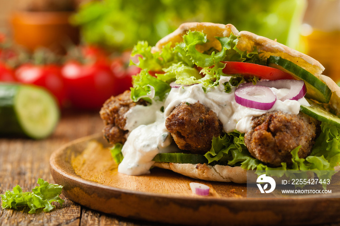 Kebab, kofta in pita, bun. Traditional southern European dish. Front view.