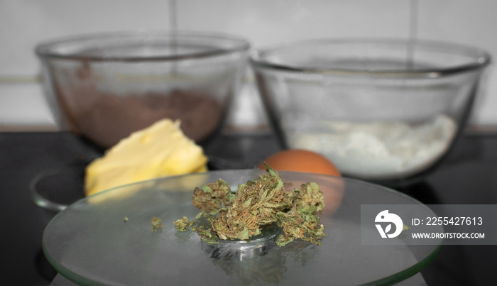 Cooking with marijuana. Cannabis buds and other ingredients prepared for cooking a sweet dessert. Blur background with copy space top.