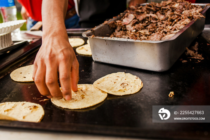 Taquero Mexican man preparing tacos al pastor in Taqueria in Mexico city