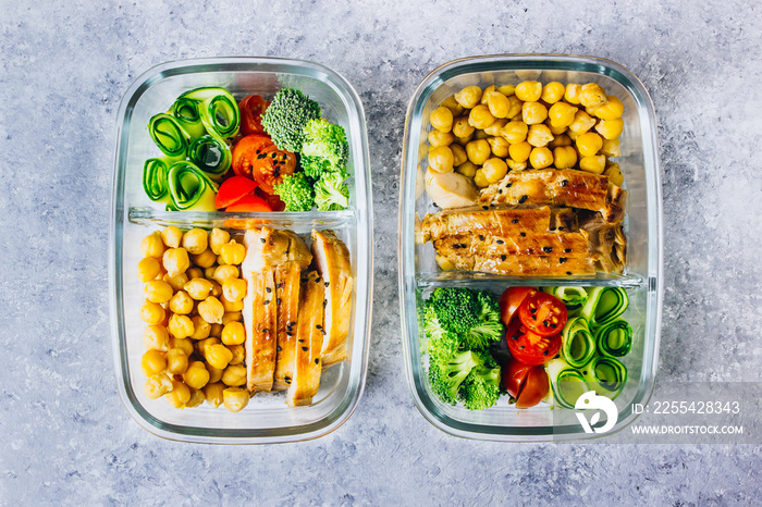 Healthy meal prep containers chicken and fresh vegetables.