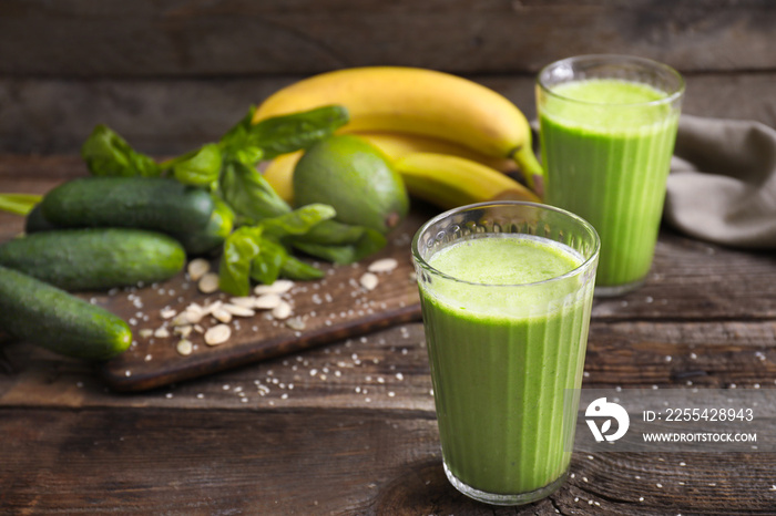 Glasses of healthy smoothie on wooden table