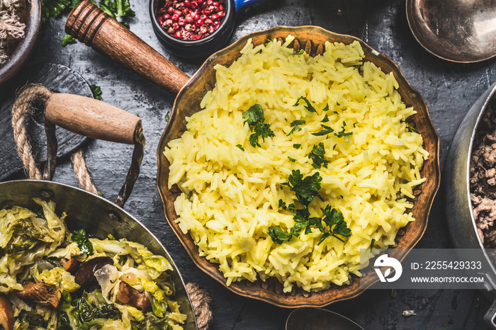 Easy Yellow Rice  flavored with Saffron in cooking pan on rustic background, top view