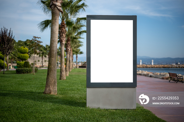 billboard mockup. Blank vertical outdoor billboard mockup on green city street. Billboard, banner, empty, white. Sunny summer day.