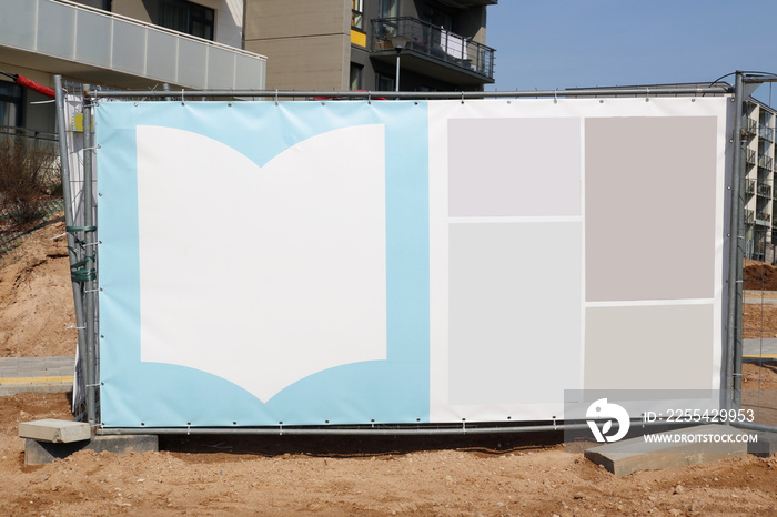 Blank advertising canvas on the fence of a city new building