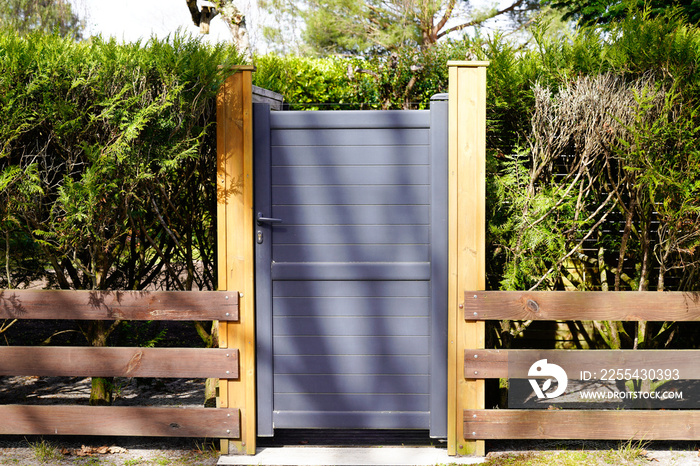 small door grey dark metal aluminum house with wooden slats garden access