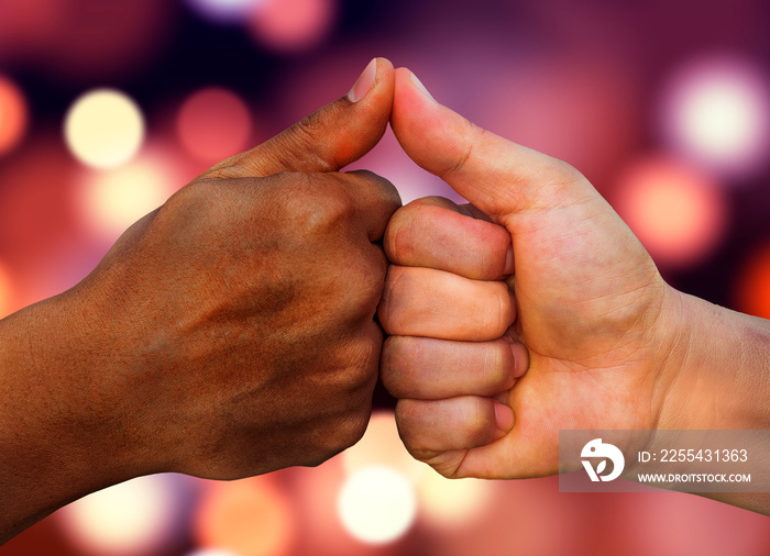 multiracial hands together African American and Caucasian touching thumbs as team in promise sign of mutual trust representing world diversity respect