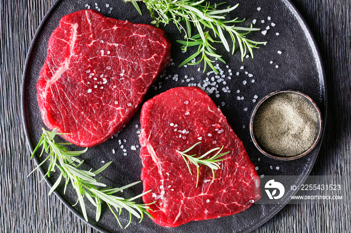 dry-aged beef steaks on a black plate