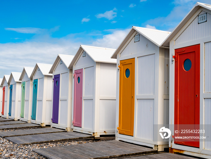 Row of traditional bathing huts with pastel colored doors at Le Treport beach, Normandy, France