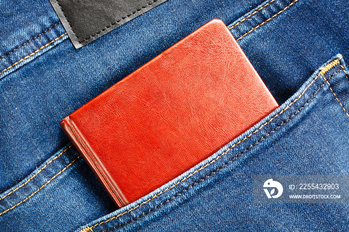 Notebook in blue jeans back pocket