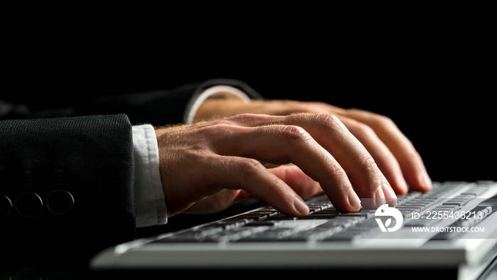 Businessman working on computer by typewriting on the keyboard