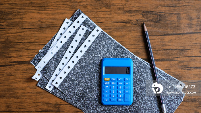 Top view, Carbon payslips and calculator on wood background.